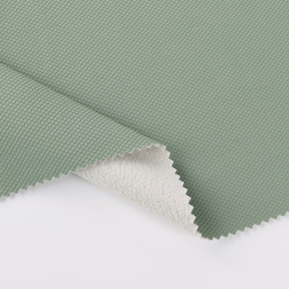 Green laminated functional fabric close-up for B2B sourcing